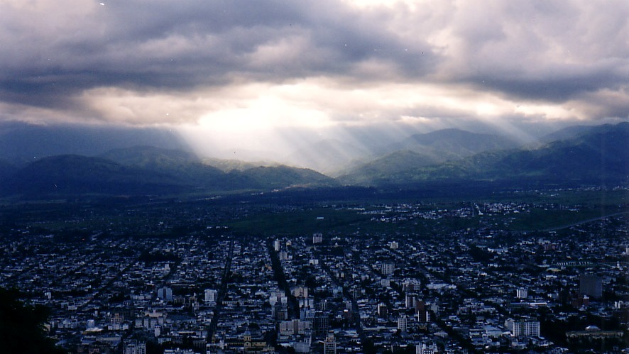 Sun breaking through the sky - Salta, Argentina - taken from a moving gondola 